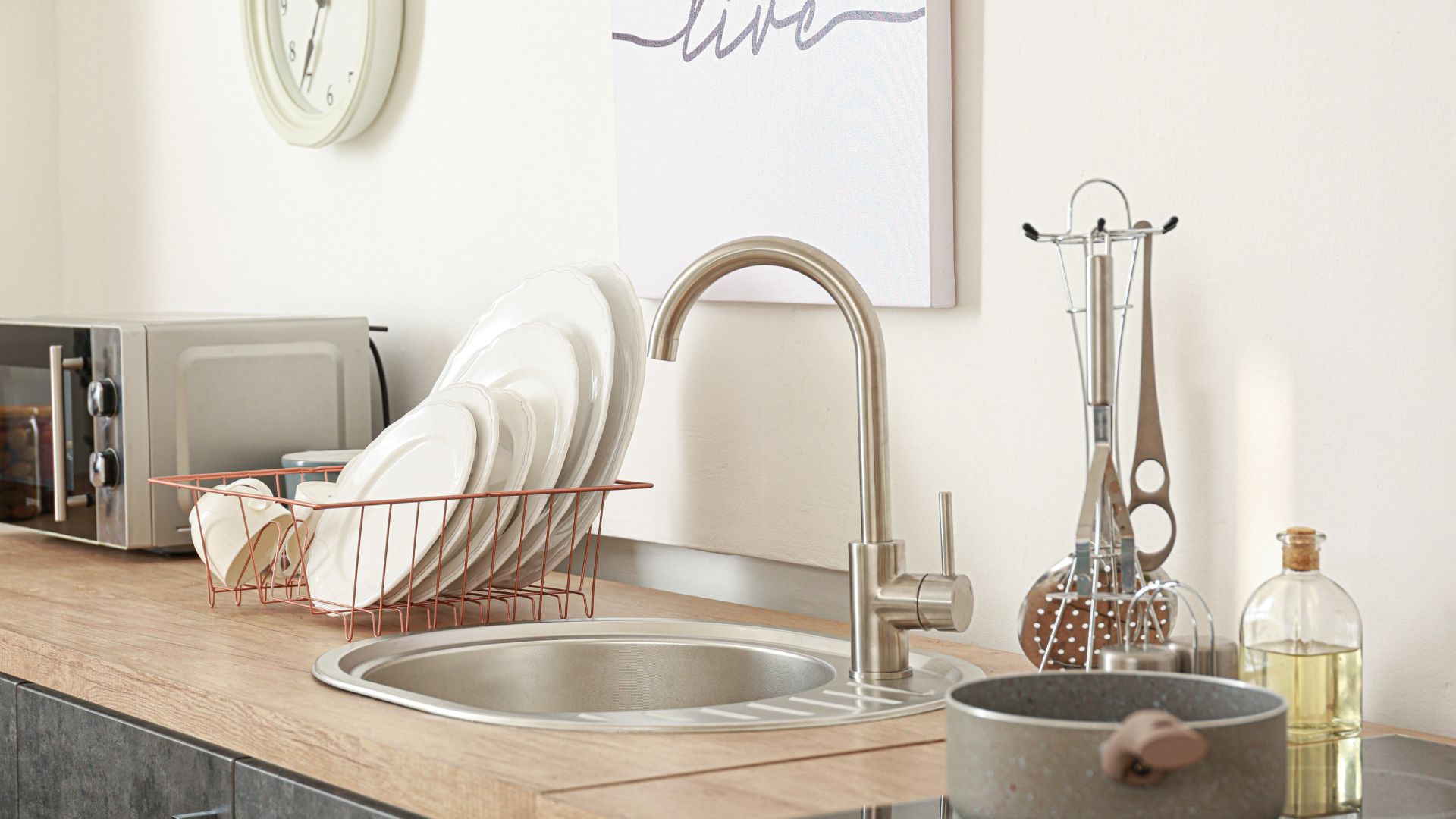 A kitchen counter with dishes and a microwave