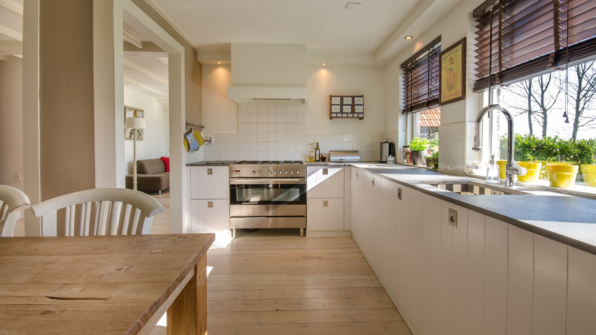 A kitchen with a wooden table and white cabinets